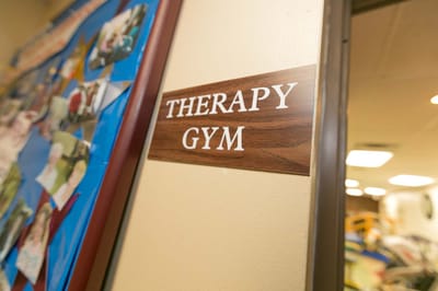 Sign for the therapy gym in a hallway