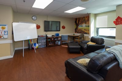 Activity room with seating and a TV