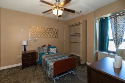 A private resident bedroom with blue decor and a bed