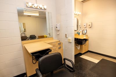 Hair salon area with mirrors and chairs