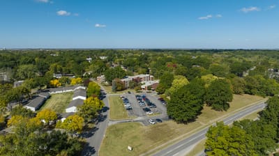 Aerial view of a senior living facility with green landscape