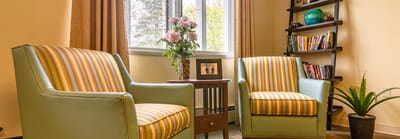 Cozy lounge area with armchairs and plants