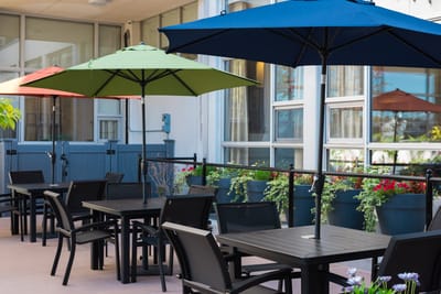 Outdoor dining area with colorful umbrellas and seating