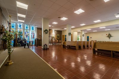 Interior view of a communal area with stained glass windows