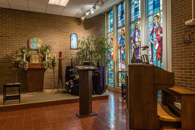 Interior view of a chapel with stained glass windows