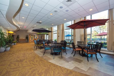 Bright common area with tables and umbrellas