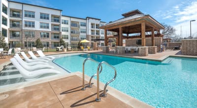 A well-maintained outdoor pool area with cabana