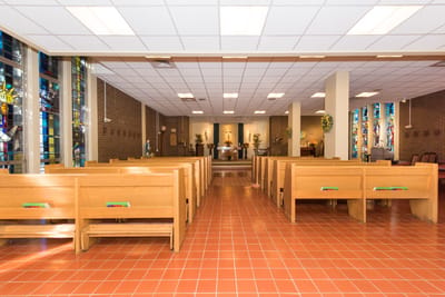 Interior view of a chapel with wooden pews