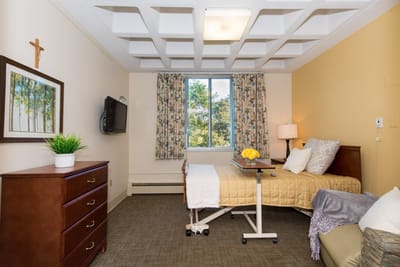 Cozy private resident room with a bed and window view