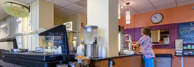 Resident serving food at a café counter