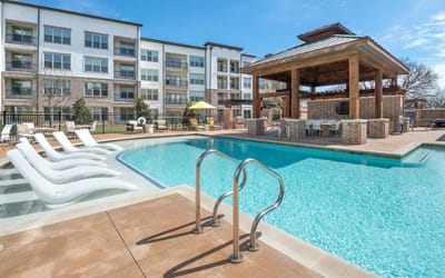 Outdoor pool area with seating and a gazebo