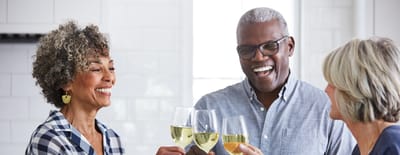 Residents toasting with glasses of wine in a bright interior