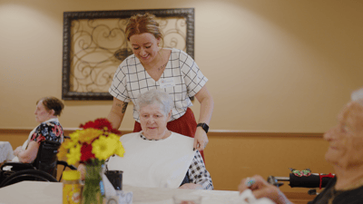 Staff assisting a resident in a common area