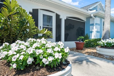 Well-maintained flowerbeds in front of a facility entrance
