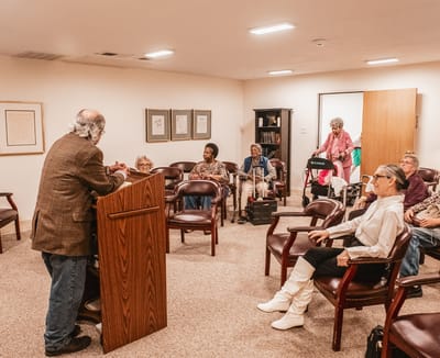 Residents attending a speaker event in a common area