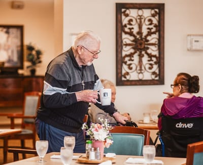A staff member serving coffee in the dining area