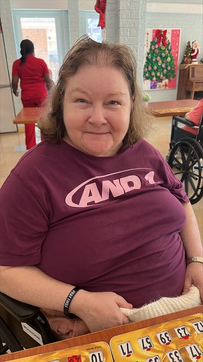 Resident enjoying a bingo game in the common area