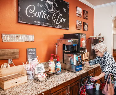 Resident enjoying coffee at a facility coffee bar