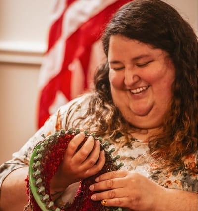 Resident smiling while engaged in an activity