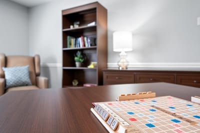 A Scrabble game set on a table in a cozy room