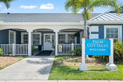 Exterior view of Palm Cottages with welcome sign