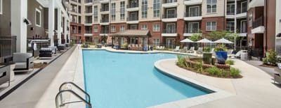 Outdoor swimming pool area with seating and shaded gazebo