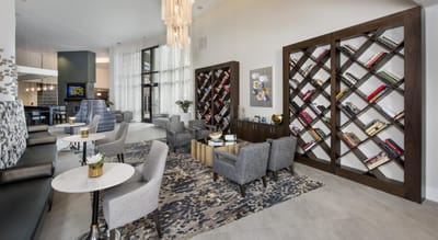 Bright common area with comfortable seating and bookshelves