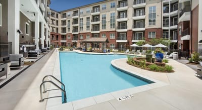 Swimming pool area with lounge chairs and landscaping