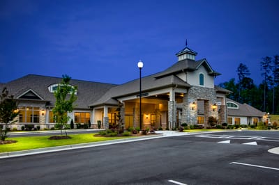 Exterior view of Orchard Senior Living facility at dusk