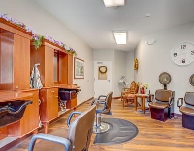 Beauty salon area with styling stations and chairs