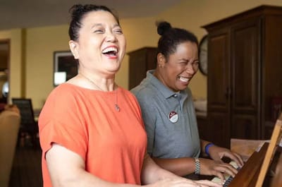 Residents and staff enjoying music together in a common area