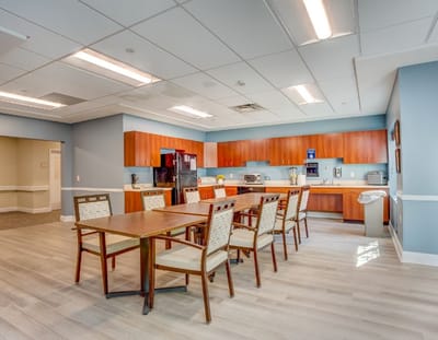 Bright common area with dining table and kitchen appliances