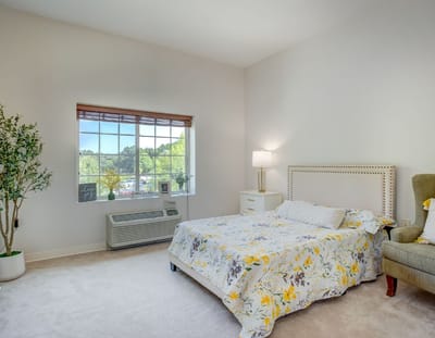 Cozy resident room with a bed and window view