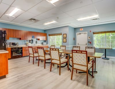 Bright common area with dining tables and chairs