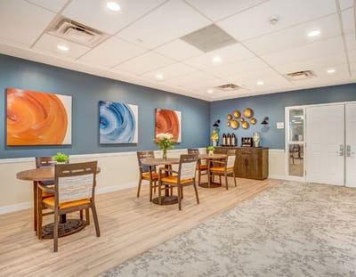 Interior seating area with tables and artwork
