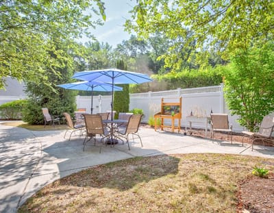 Outdoor seating area with umbrellas and gardens
