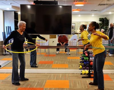 Residents participating in a hula hoop exercise class