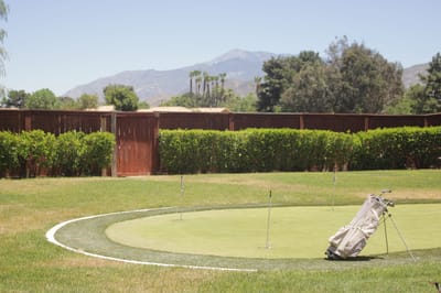 Outdoor putting green with mountains in the background