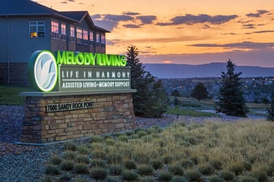Facility logo displayed at sunset with landscaping