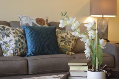 Tastefully decorated living room with flowers and pillows