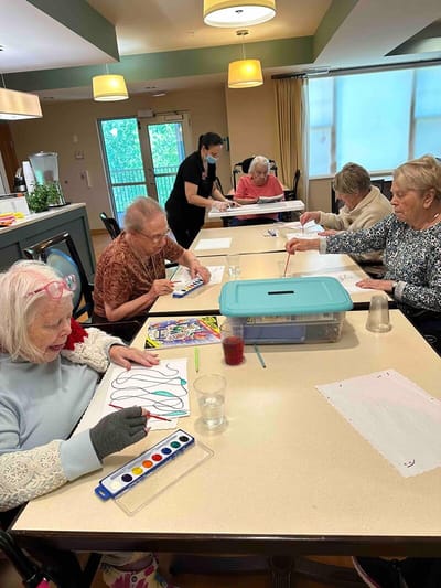 Residents enjoying an art activity in a common area