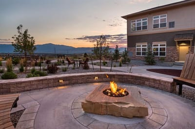 Outdoor seating area with a fire pit and mountain backdrop