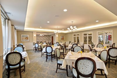 Bright dining room with tables set for meals.