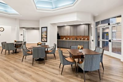Bright and spacious common area with dining tables