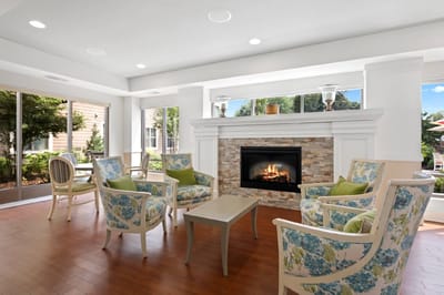 Bright and inviting common area with seating and fireplace
