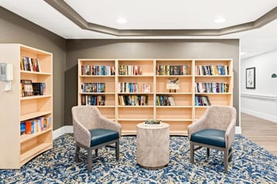 Cozy reading area with bookshelves and armchairs