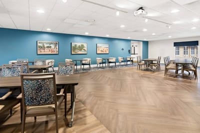 Bright activity room with tables and artwork
