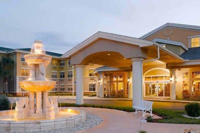 Entrance of the facility with a fountain and architectural features