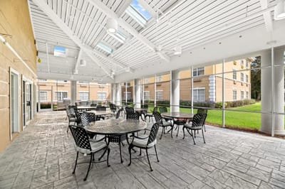 Covered outdoor seating area with tables and chairs