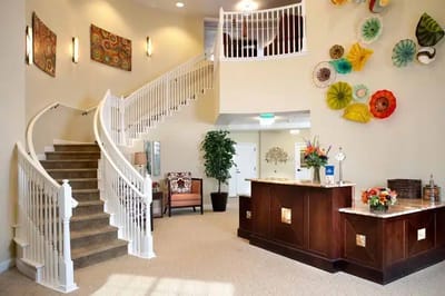Bright lobby with spiral staircase and colorful wall art